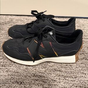 New Balance Black Sneakers with Red and Yellow Accent Stripes and Gum Sole